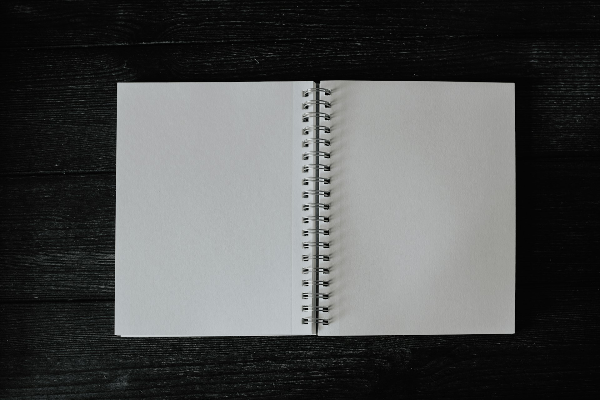 an open notebook on a wooden table